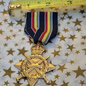 Gold This is a replica of the 1914–15 Star, a British Empire  Medal with Ribbon